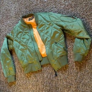 Green bomber jacket with pocket in the sleeve